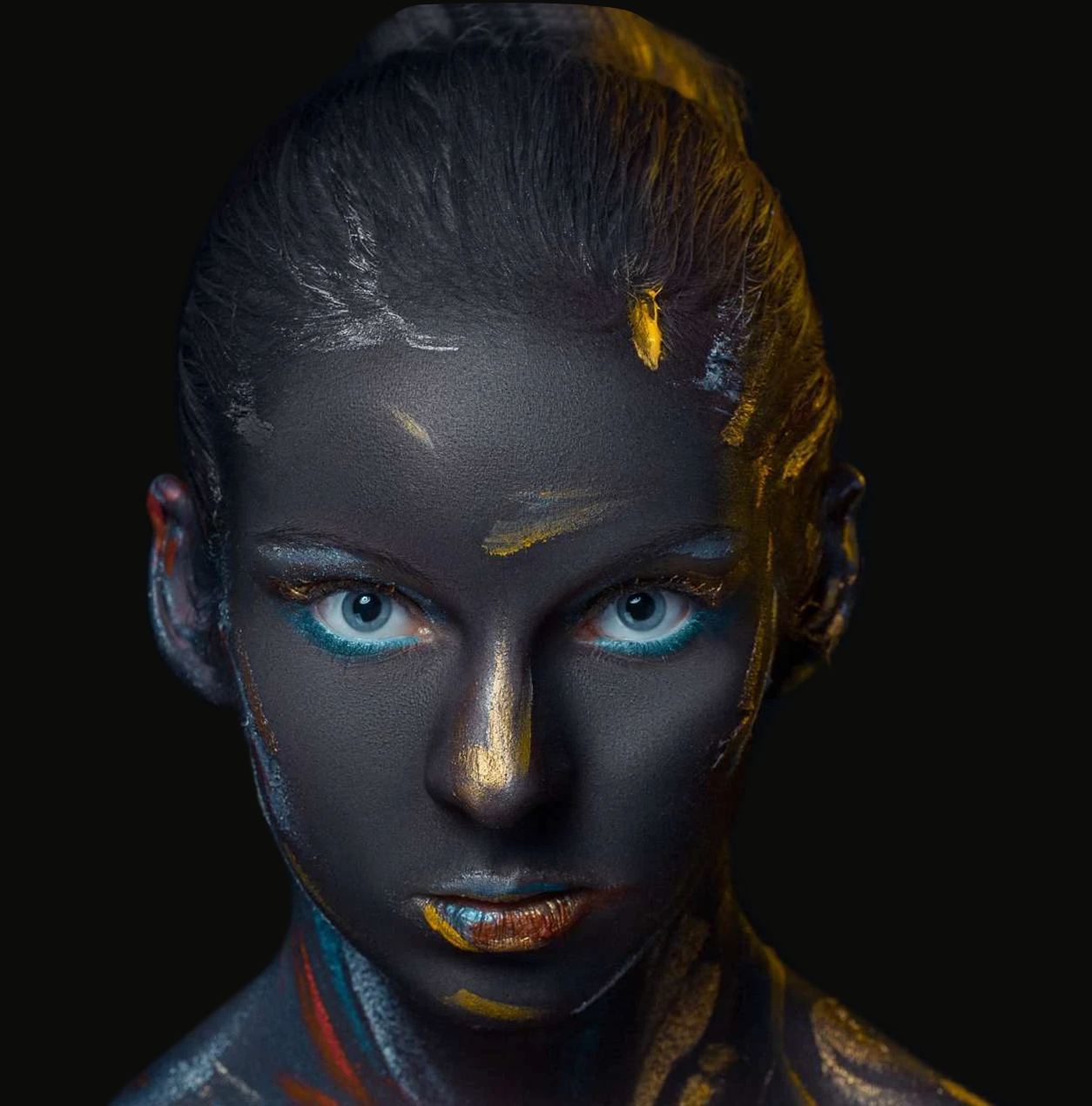 Creative portrait with charcoal, gold and turquoise accents fading into a dark background